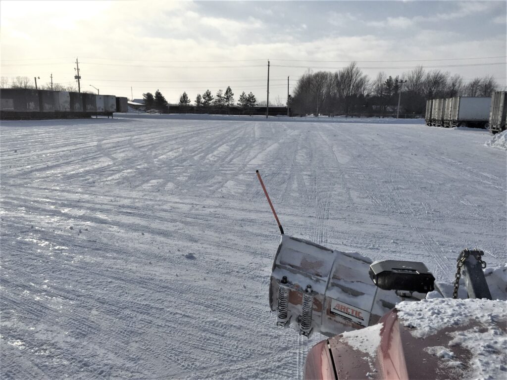 Empty parking lot in the winter that has just been plowed